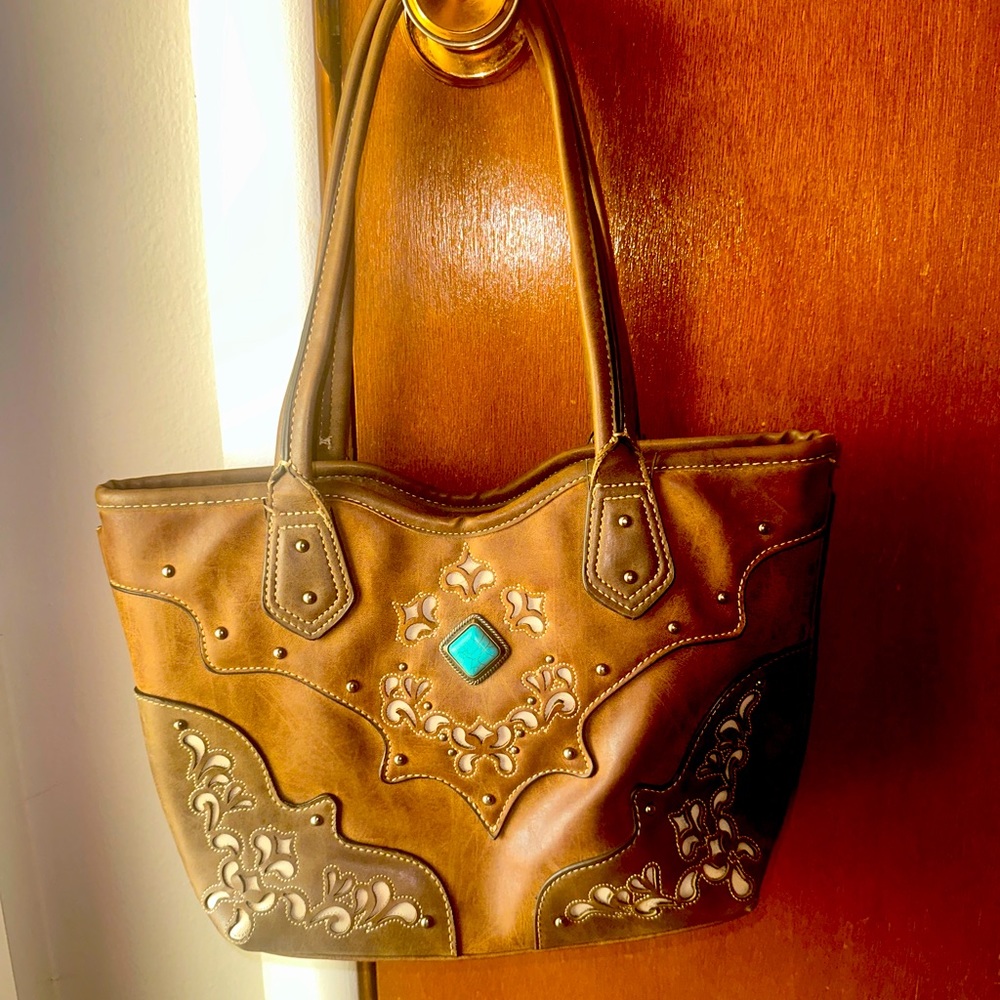 Brown leather western style purse.